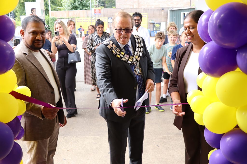 Image shows Mayor cutting ribbon at reopening.