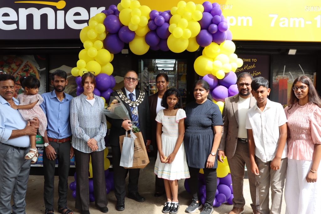 Image shows Mayor and owners of the Robin Hood Service Station.